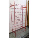 A Herby red painted metal wine rack