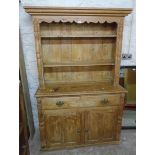 A 4' 2 1/2" 19th Century stripped pine two part dresser with moulded cornice and flanking applied