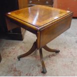 A 30" reproduction figured walnut veneered cross banded and strung drop-leaf tea table, set on
