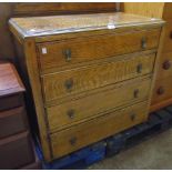 A 33" early 20th Century polished oak chest of four long graduated drawers, set on simple block