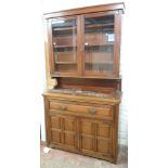 A 4' Edwardian walnut secretaire bookcase with pierced brass strap hinges to glazed top, flanking