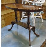 A 29" reproduction mahogany cross banded and strung oval tray top occasional table, set on