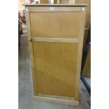 A 25 1/2" 20th Century waxed pine and mixed wood hall cupboard with hanging space enclosed by a