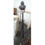 A wrought iron standard lamp