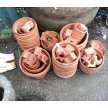 A collection of modern terracotta plant pots and risers