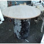 A 36 1/2" diameter pine topped garden table, set on a base from an old riveted boiler