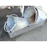 Three galvanised buckets and a trough