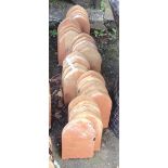 Thirty old terracotta mitre shaped edging tiles