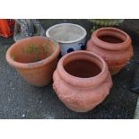 Four terracotta plant pots comprising a pair and two others