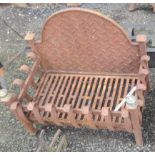 A wrought and cast iron fire basket with back plate