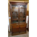 A 4' Edwardian walnut two part book cabinet with adjustable shelves enclosed by a pair of glazed