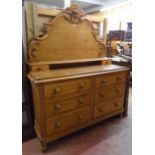 A 4' 6" Victorian waxed pine dresser with decorative C-scroll and acanthus decorated shaped raised