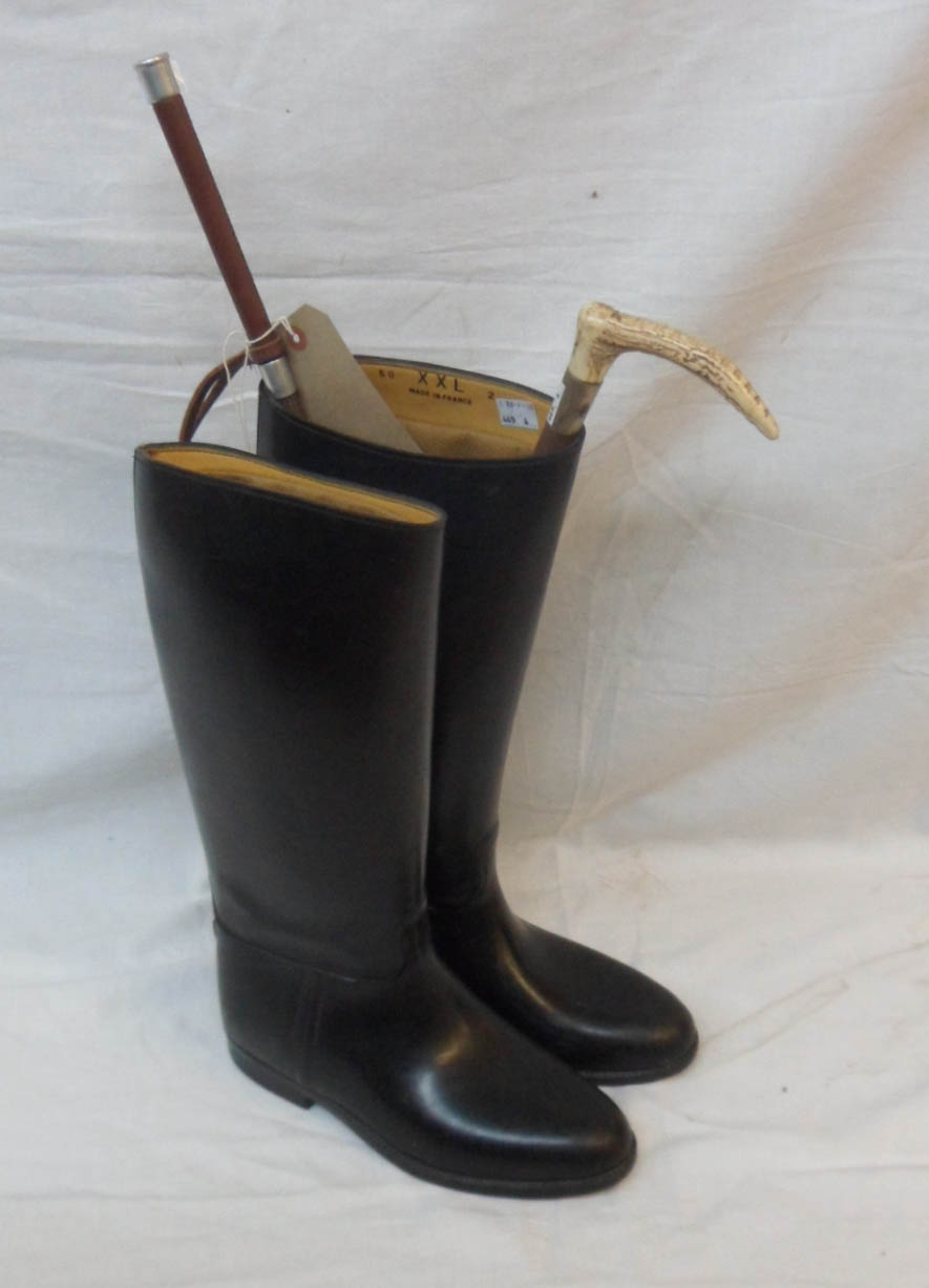 A pair of French rubber riding boots - size 40 - sold with two riding crops