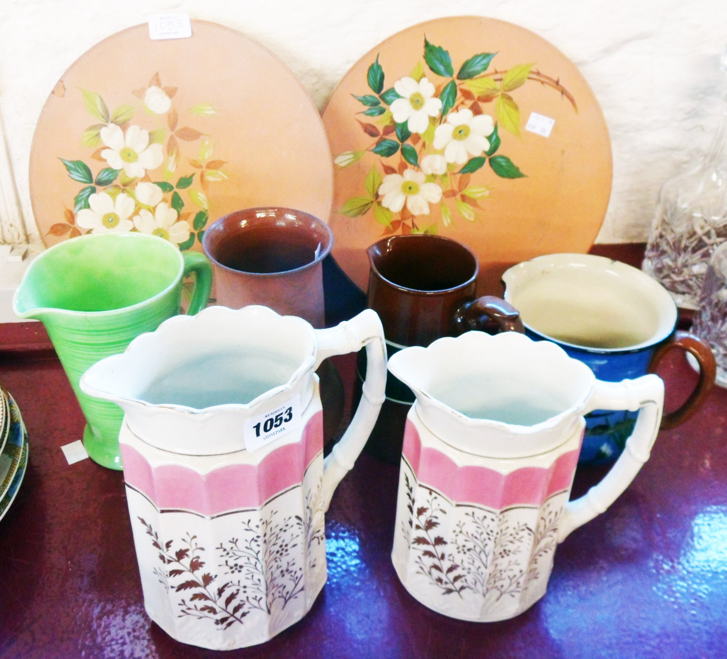 Five assorted jugs, a Watcombe terracotta vase and two terracotta plaques with apple blossom