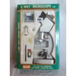 A vintage boxed three way microscope by Scientific Educational Hobby