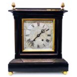 An antique ebonised cased table clock with acorn finials and 7 1/2" engraved silvered dial, with Hy.
