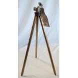 A vintage brass and steel telescopic camera tripod