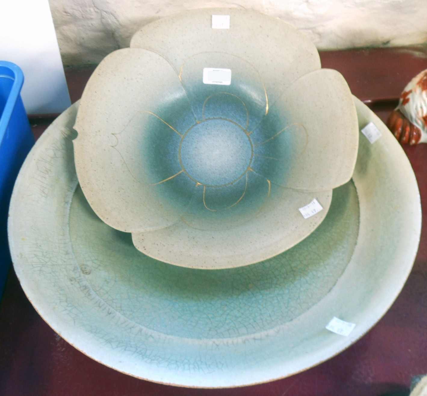 A large shallow Raiku pottery bowl and a decorative petal pattern bowl