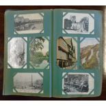 A postcards album containing a large collection of mainly early 20th Century postcards including