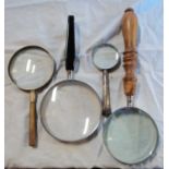 Four magnifying glasses including a Sheffield 1902 silver handled example - various sizes