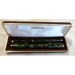 A boxed Rotring fountain and ball pen set with gilt and green malachite finish