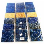 A quantity of early 20th Century cobalt blue and mustard yellow glazed tiles by Jackson of Stoke
