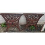 A pair of 19th Century ornate cast iron table ends