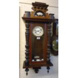 An early 20th Century stained walnut cased Vienna style wall clock with Arabic numerals, visible