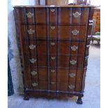 A 34 1/2" polished hardwood serpentine front chest in the antique style with six long drawers and