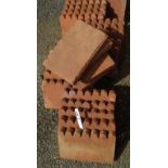 Thirty four scalloped shaped terracotta edging tiles