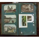 An album containing a collection of mainly early 20th Century postcards including greetings,