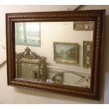 A moulded oak framed bevelled oblong wall mirror