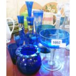A collection of blue glass items including vases, glasses, etc.