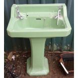 A vintage green pedestal sink
