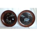 A pair of 18" diameter Japanese lacquered wall plaques with inlaid mother-of-pearl decoration