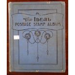 A blue The Ideal Postage stamp album containing a collection of part contents of hinge mounted