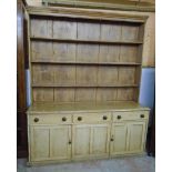 A 6' 4" Victorian waxed pine two part dresser with three shelf open plate rack over a base with