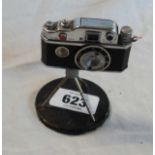 A vintage camera pattern cigarette lighter with tripod and base - cable release missing