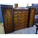 A 7' 10 1/2" 19th Century flame mahogany veneered dressing unit of architectural design with central