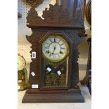 A late 19th Century American stained wood gingerbread shelf clock with Waterbury Clock Co., gong