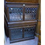 A pair of 35" Minty polished oak bookcases, each enclosed by a pair of leaded glazed panel doors -