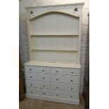 A 4' 6" modern two part painted pine dresser with pierced motifs and two shelves to open plate