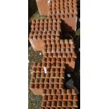 Thirty scalloped shaped terracotta edging tiles