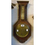 A 20th Century polished oak cased aneroid wall barometer with thermometer scale, flanking barley