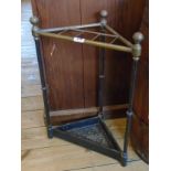 A 17" old brass and cast iron corner stick stand with triple slender supports