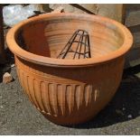 A large modern terracotta planter - sold with a metal hanging basket