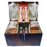 A mid-late 18th Century captains or travellers decanter set in iron bound stained oak case, the tray