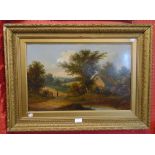 A late 19th Century gilt framed oil on board, depicting a figure in a rural landscape with cottage