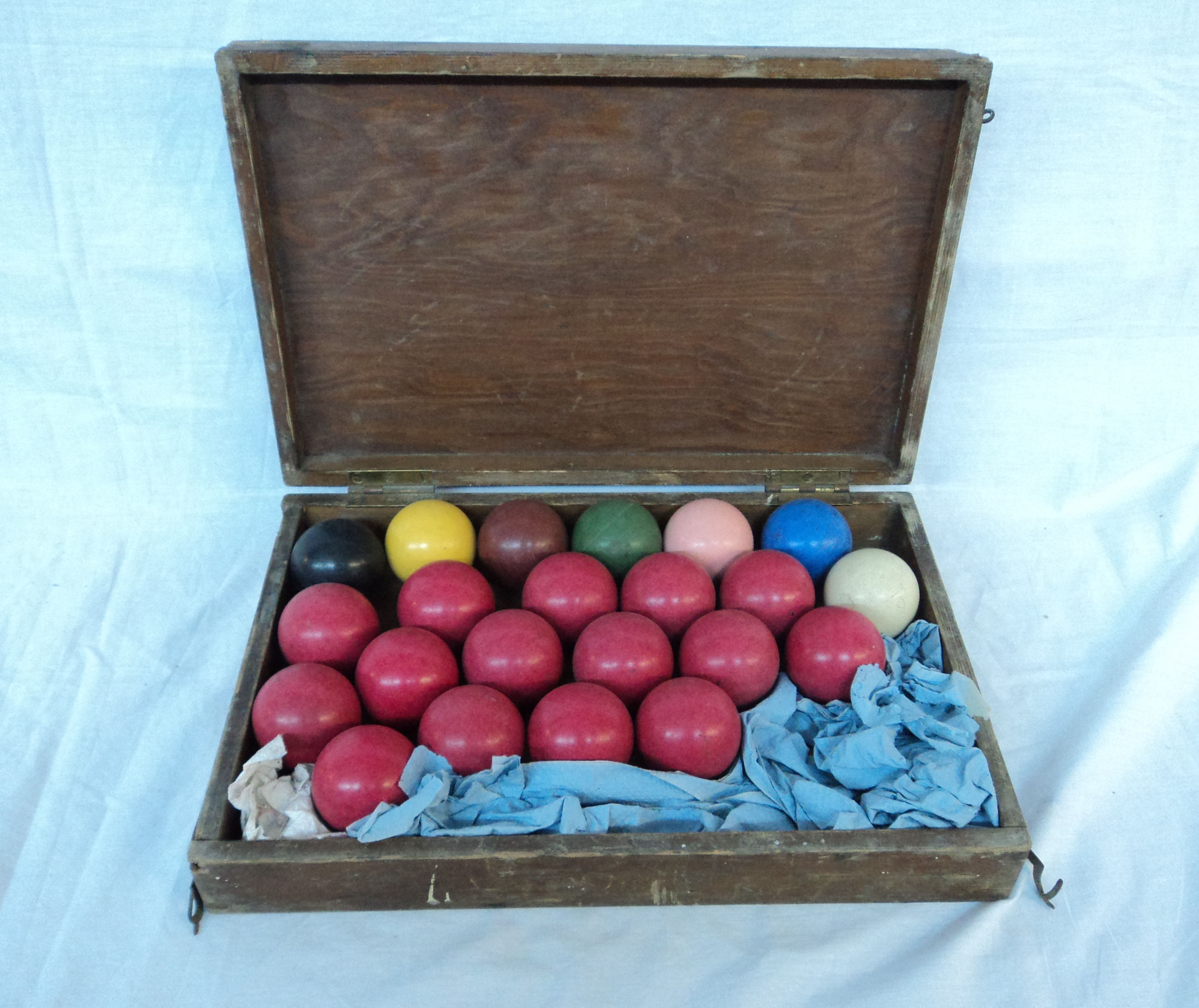 A wooden cased set of early composite snooker balls