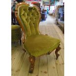 A Victorian walnut part show frame spoon back nursing chair with button back green velour